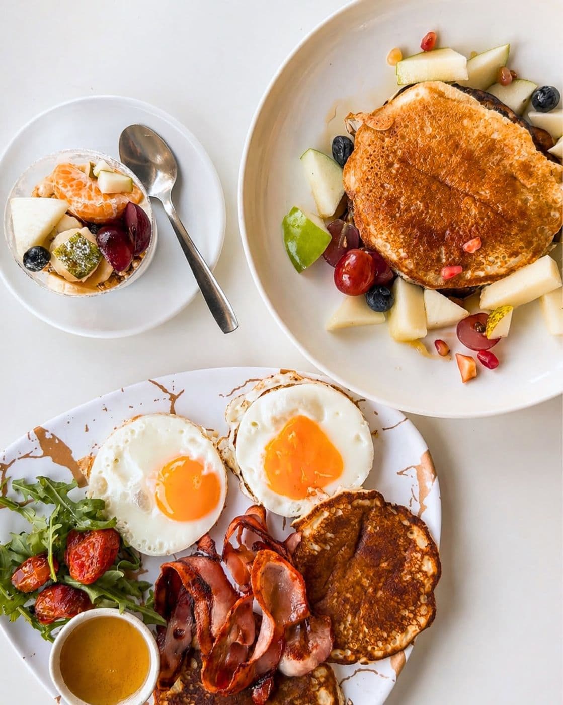 Brunch with pancakes, eggs and fresh fruit